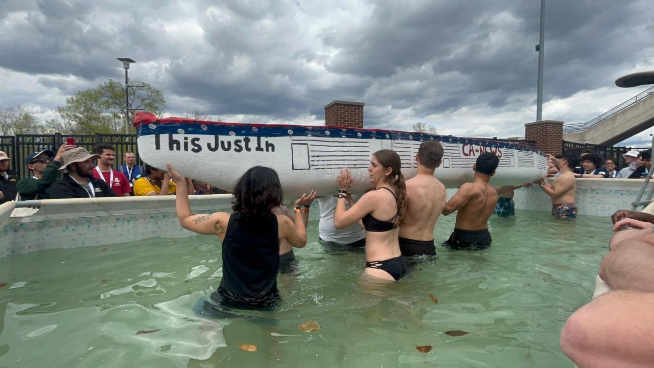 Float test — carrying the CA-NEWS canoe into the water at Nationals.